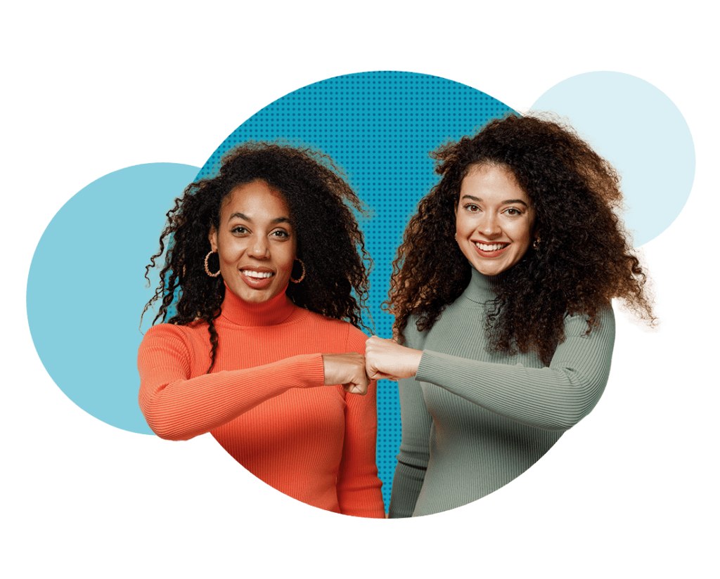 two women fist bumping 